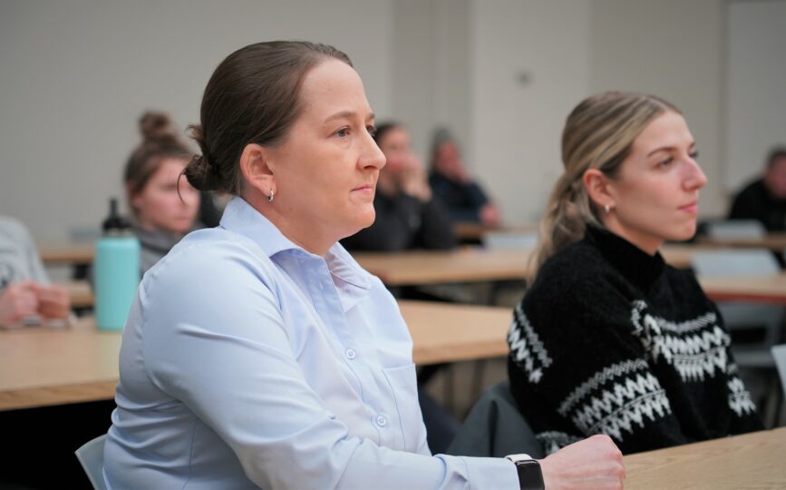 Attendee Amber Fryklund listens to a Title IX speaker panel on Wednesday, Feb. 1, 2023, in the Beaver Pride Room. Panelist Emma Terres-Sobieck acknowledged Fryklund, a former BSU women's hockey coach, as a mentor and role model to her.