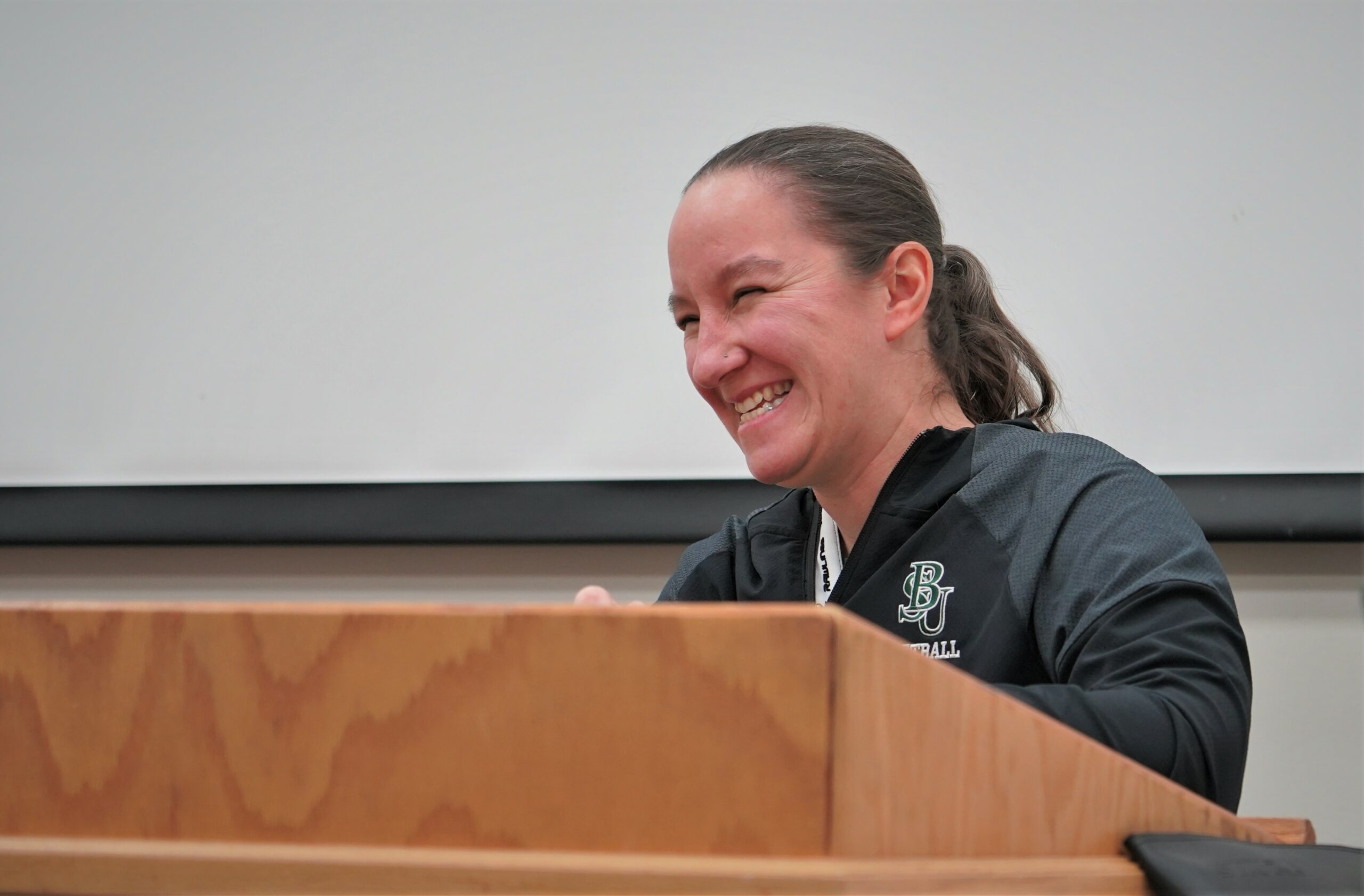 Bemidji State athletic director Britt Lauritsen laughs from the podium while moderating a Title IX speaker panel on Wednesday, Feb. 1, 2023, in the Beaver Pride Room.