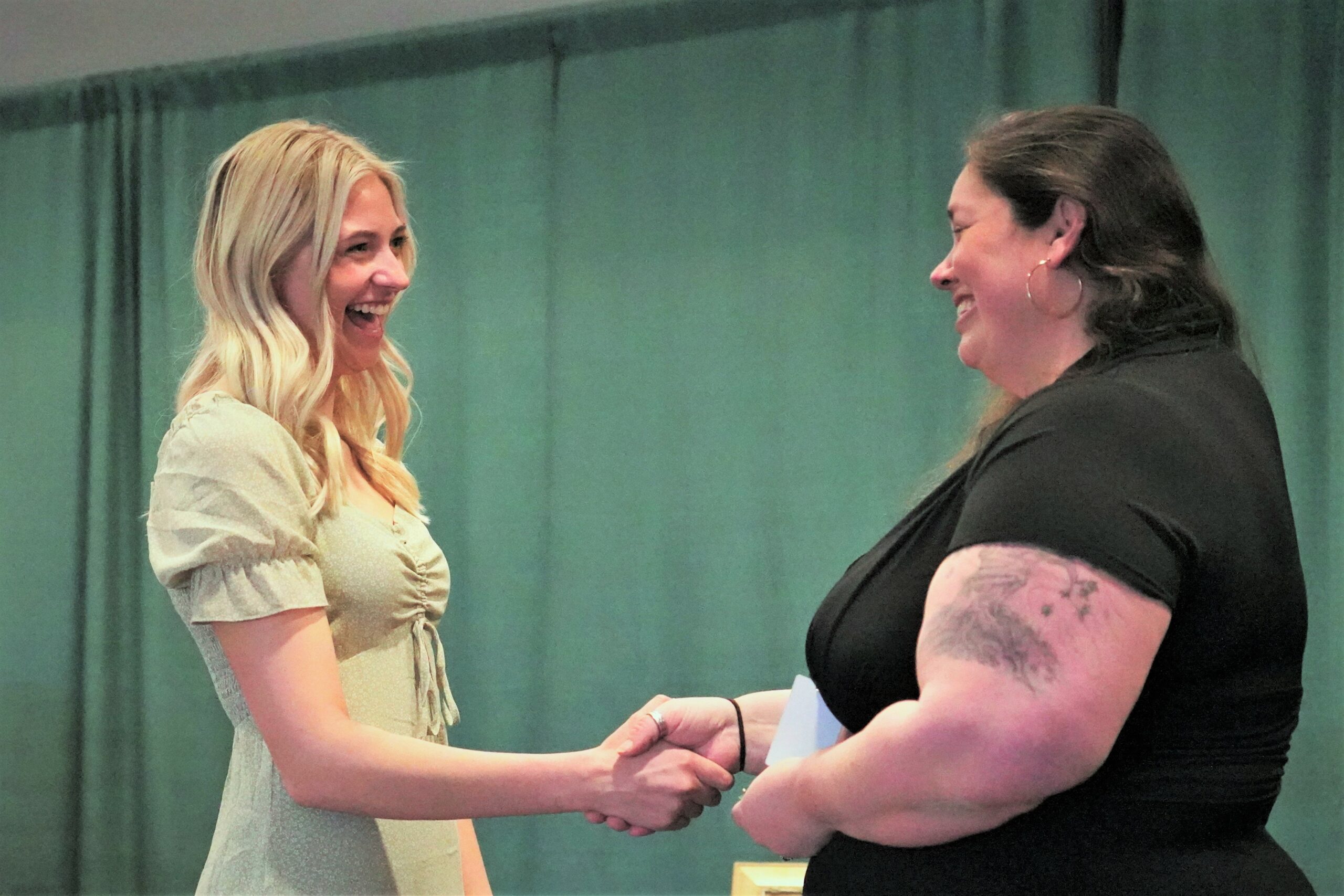 Faith Beck, left, receives her nursing pin during a ceremony on Thursday, May 4, 2023, in the Beaux Arts Ballroom. (Micah Friez / Bemidji State)