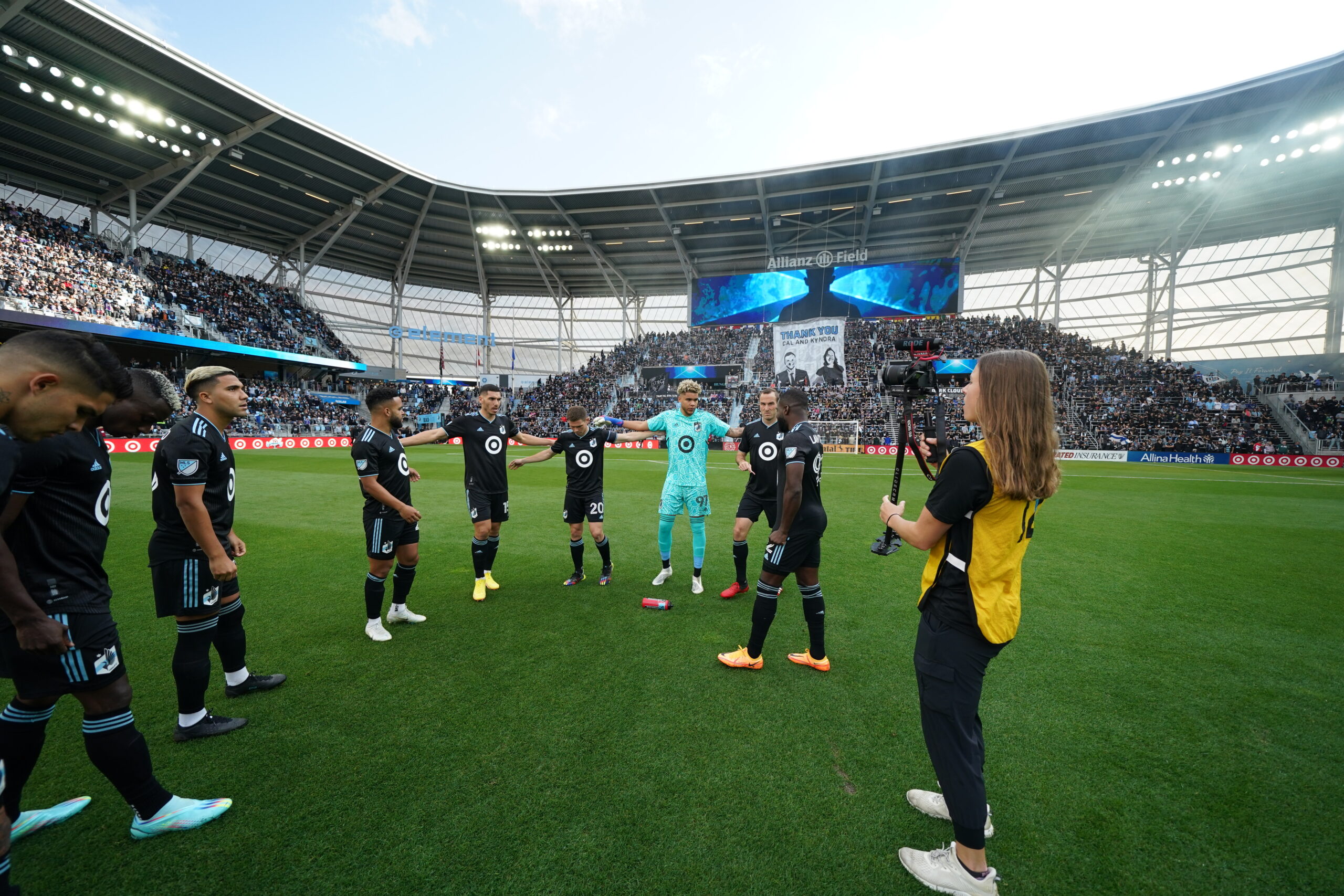 Bemidji State graduate Coley Rezabek, in yellow, shoots footage of Minnesota United players at a September 2022 game at Allianz Field in St. Paul. (Contributed)