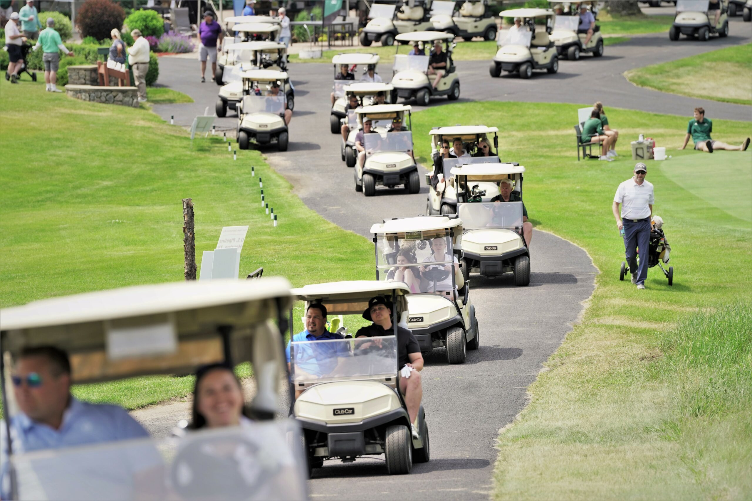 Golf carts zip off to their tee boxes for a shotgun start to the afternoon portion of the 46th annual Gordy Skaar Memorial Golf Tournament on Friday, June 16, 2023, at the Bemidji Town and Country Club. (Micah Friez / Bemidji State)