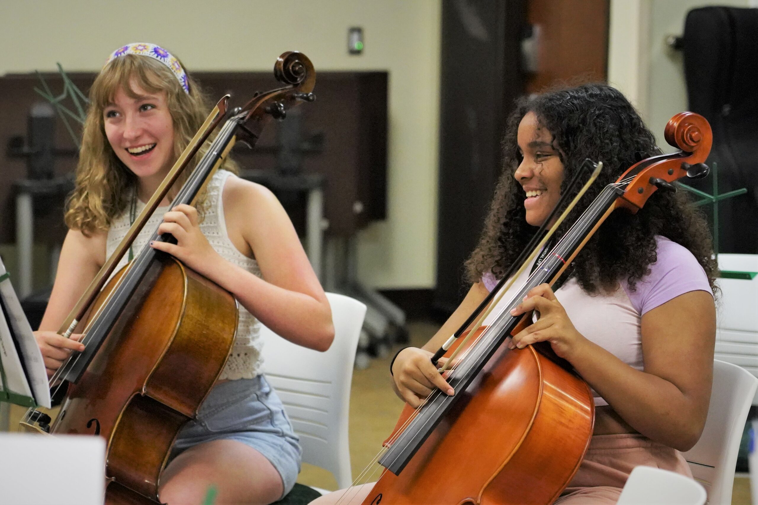 Campers share a laugh while playing the cello during MusiCamp on Wednesday, July 19, 2023, in Memorial Hall. (Micah Friez / Bemidji State)