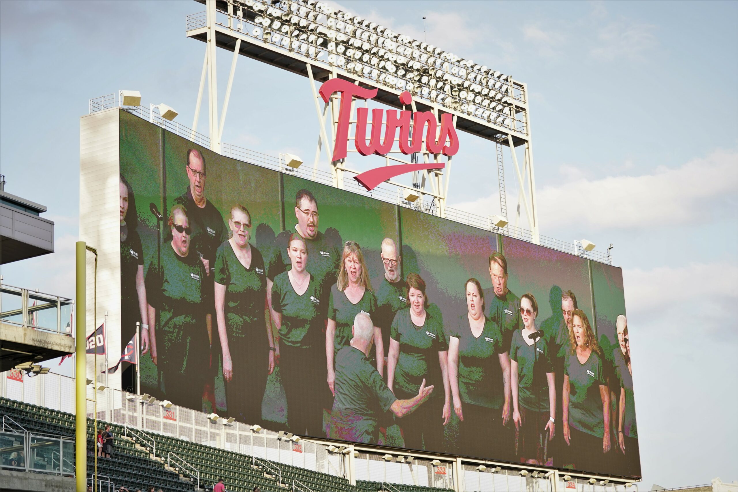 The Bemidji Alumni Choir graces the big screen while performing the national anthem before the Minnesota Twins hosted the Texas Rangers for BSU Night at Target Field on Friday, Aug. 25, 2023, in Minneapolis. (Micah Friez / Bemidji State)