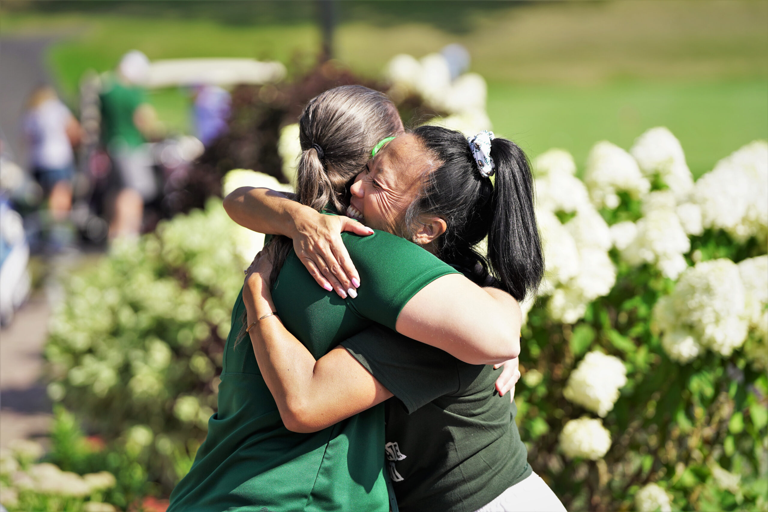 Dr. Joy Hoffman, right, hugs director of athletics Britt Lauritsen during the Howe-Welle Women's Athletics Golf Tournament on Friday, Aug. 25, 2023, at the Bemidji Town and Country Club. (Micah Friez / Bemidji State)