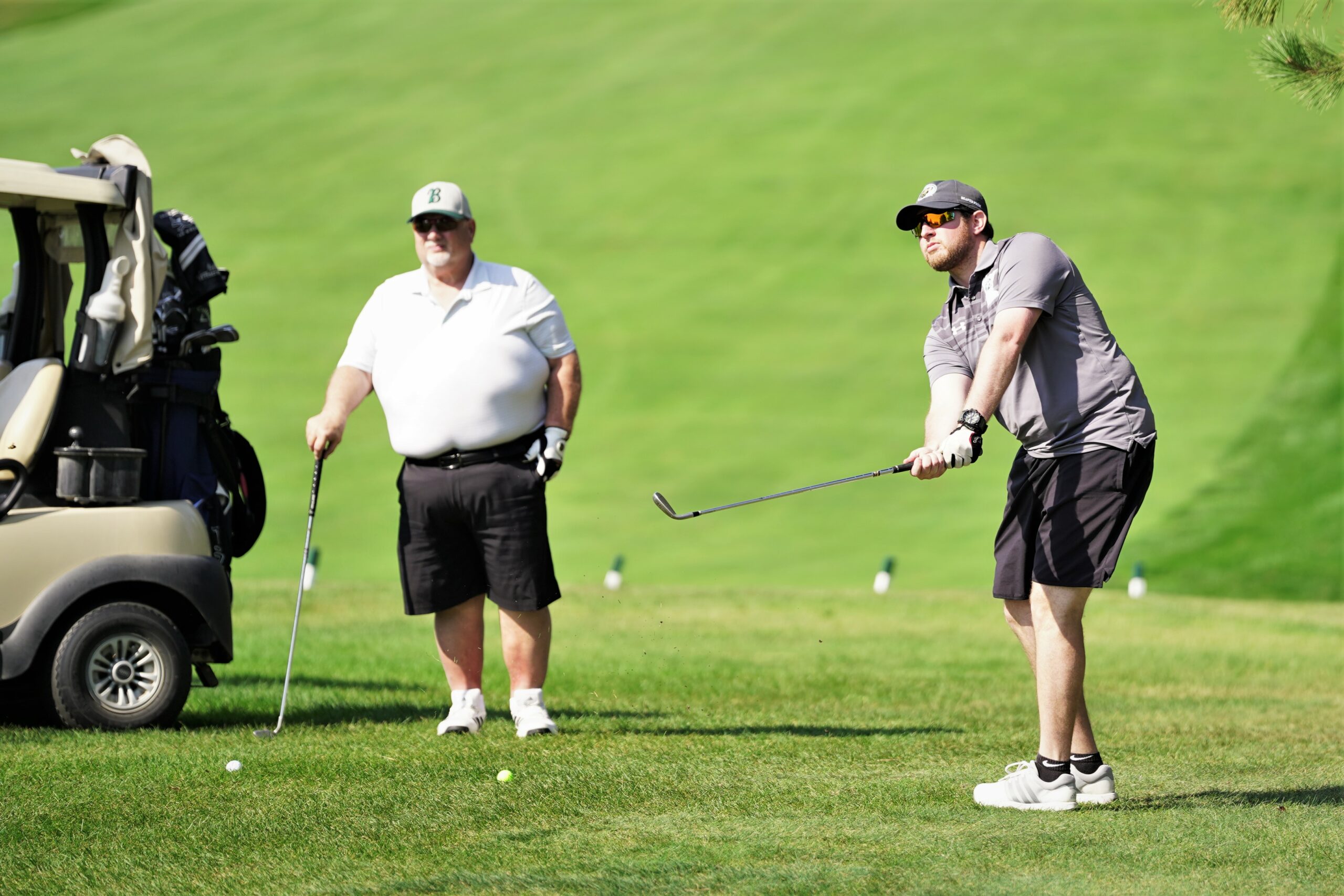 Jesse Katz, the Bemidji State Alumni & Foundation's director of annual giving for athletics, chips onto the first green during the Howe-Welle Women's Athletics Golf Tournament on Friday, Aug. 25, 2023, at the Bemidji Town and Country Club. (Micah Friez / Bemidji State)