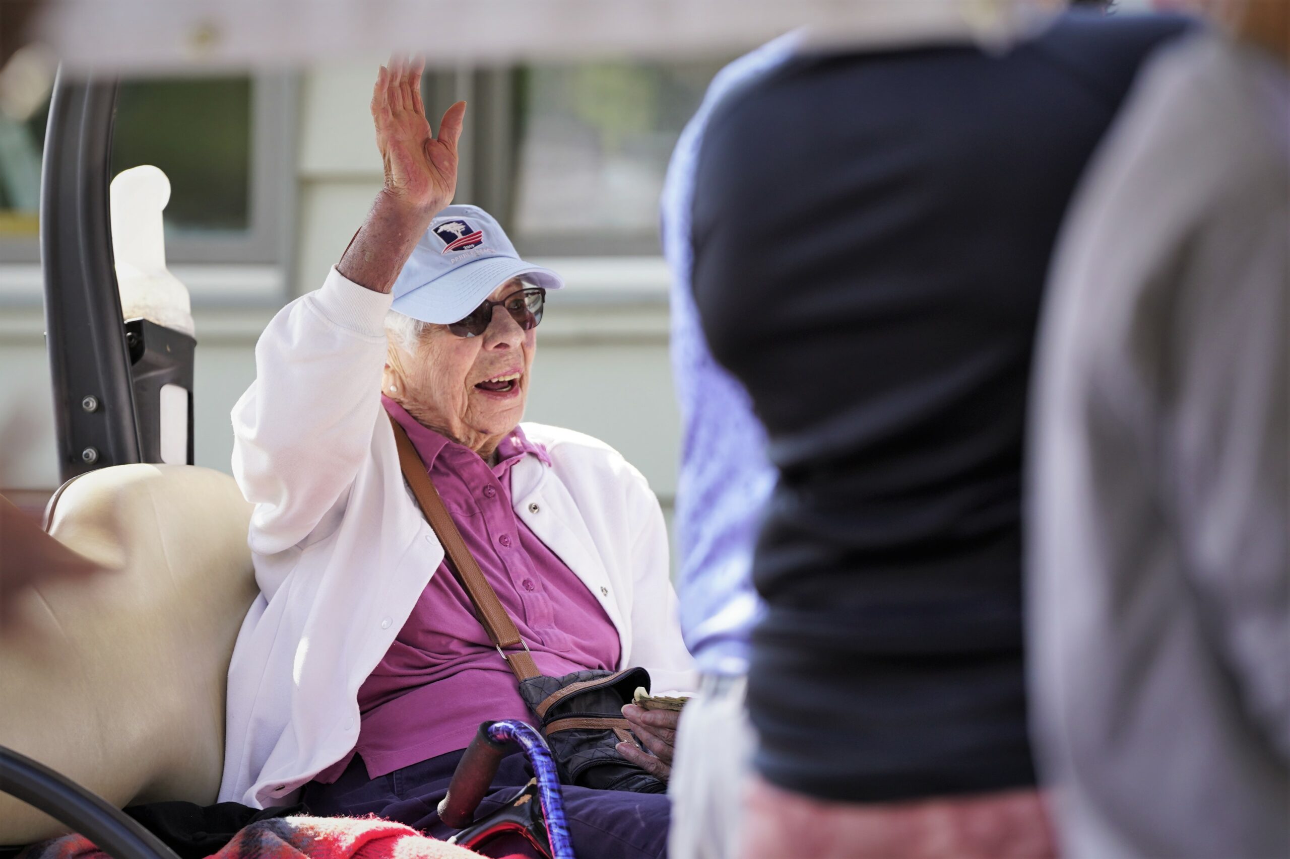 Ruth Howe, a founder of Bemidji State women's athletics and half of the namesake for the Howe-Welle Women's Athletics Golf Tournament, waves to the crowd after being acknowledged on Friday, Aug. 25, 2023, at the Bemidji Town and Country Club. (Micah Friez / Bemidji State)