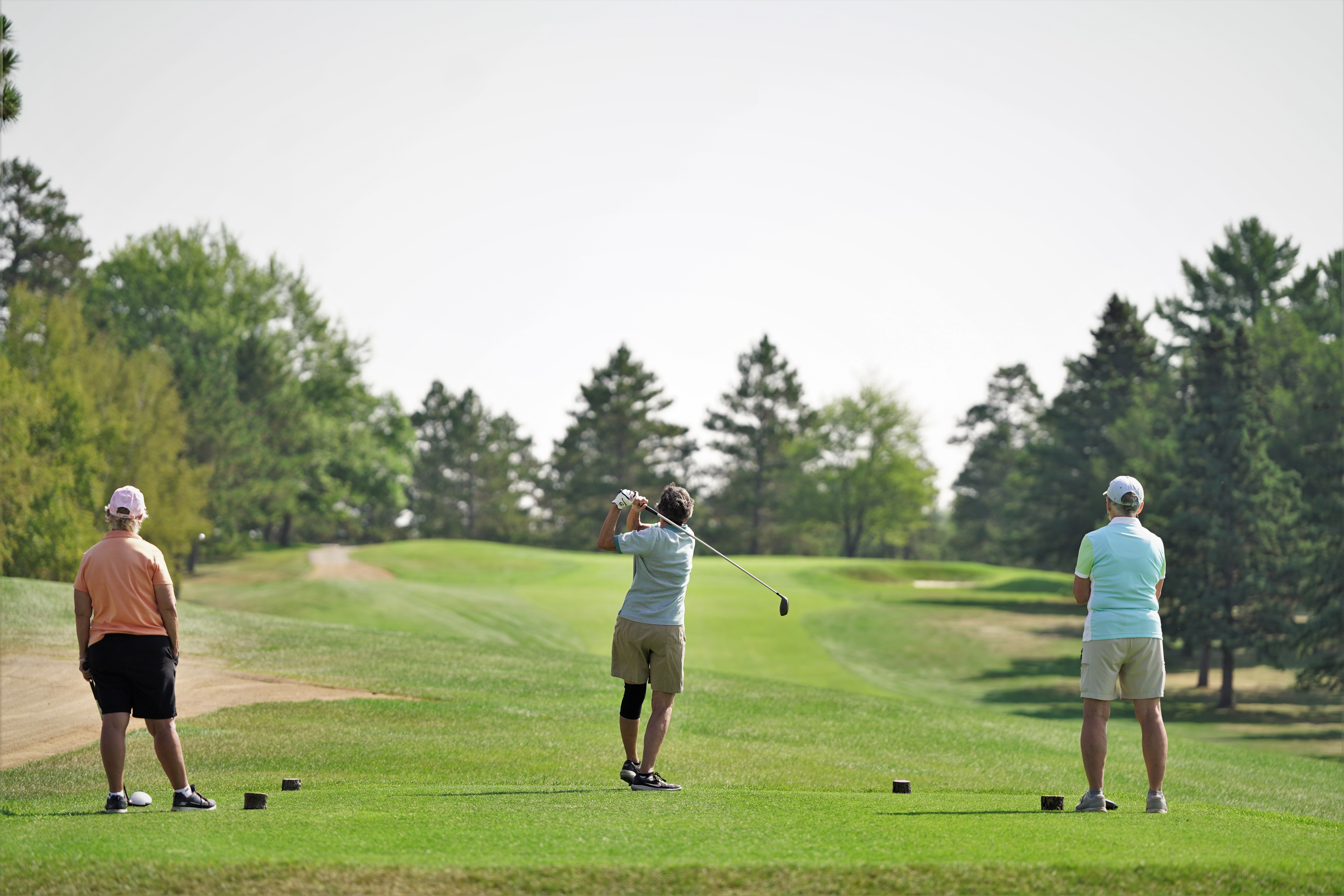 Golfers tee off on hole No. 1 during the Howe-Welle Women's Athletics Golf Tournament on Friday, Aug. 25, 2023, at the Bemidji Town and Country Club. (Micah Friez / Bemidji State)