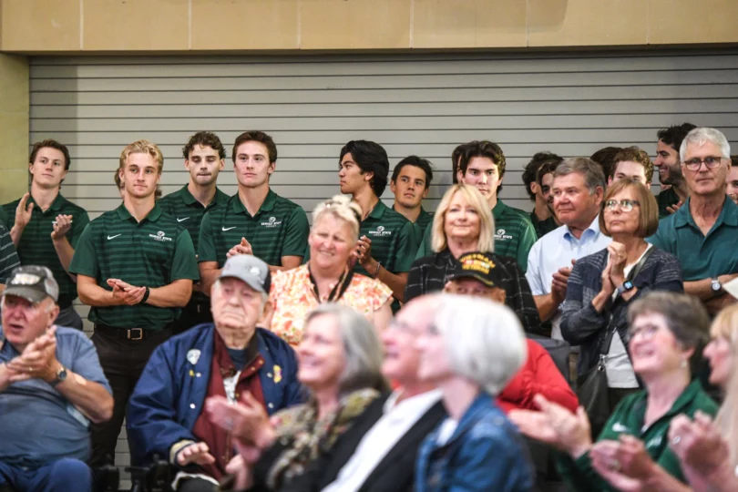 Members of the Bemidji State men's hockey team and other attendees clap for a speaker during an unveiling ceremony for a bust of R.H. "Bob" Peters at the Sanford Center on Thursday, Sept. 12, 2024, in Bemidji.Madelyn Haasken / Bemidji Pioneer